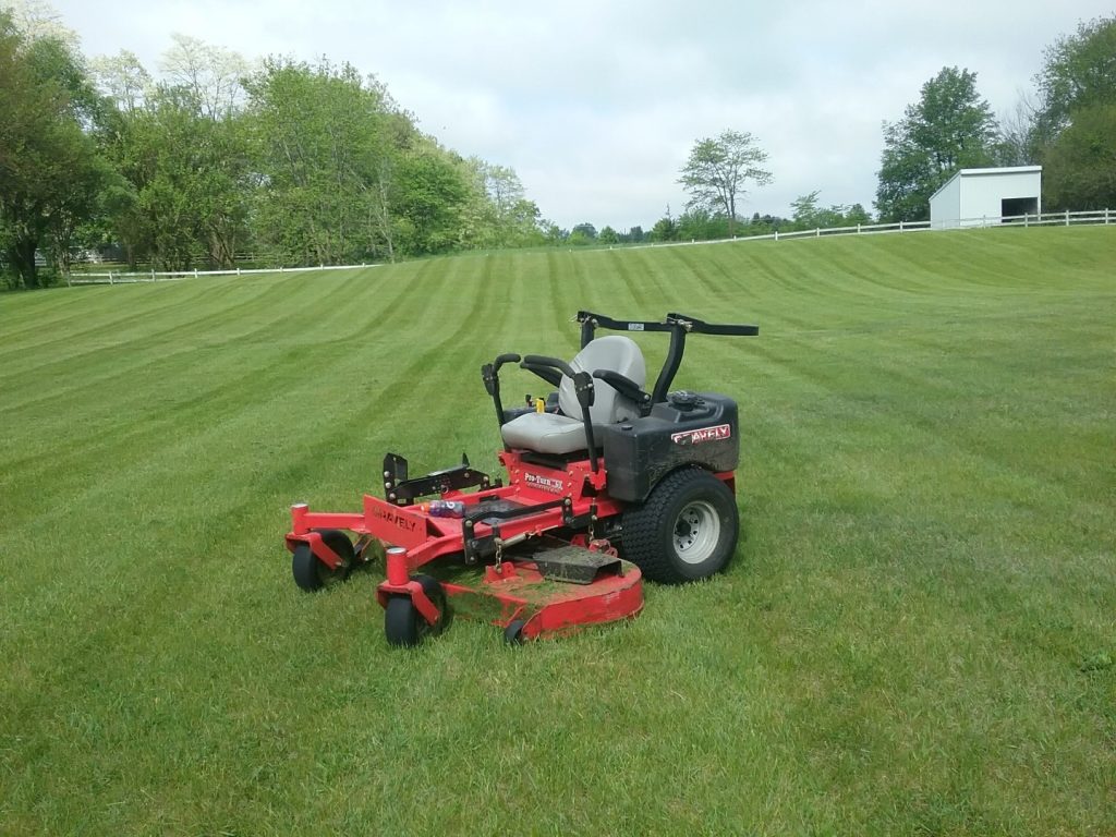 a red lawnmower in a field of grass